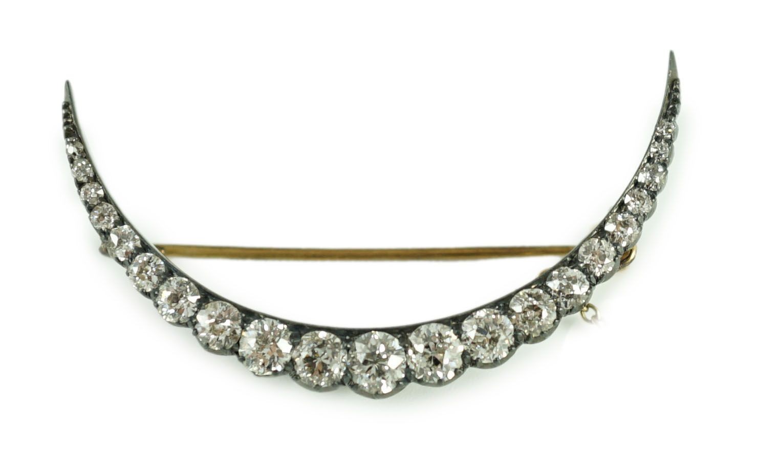 A Victorian, gold, silver and graduated twenty one stone diamond set crescent brooch